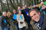 Alex Clarkson with a team of Conservative activists, there is woodland in the background.